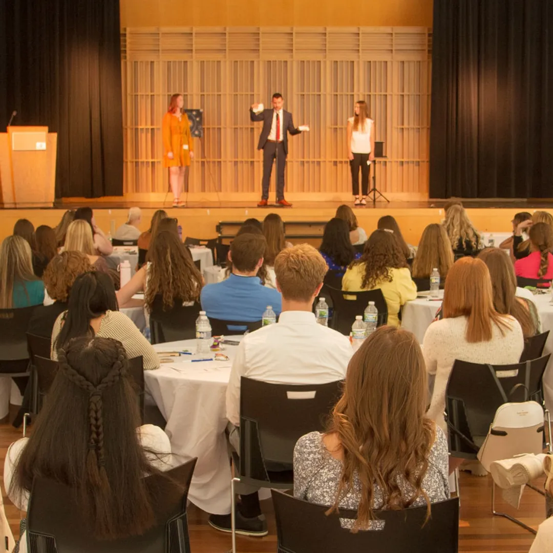 Josh Fletcher performing on stage during a keynote presentation